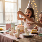 Pepper & White Alpine Alpaca shaped candles on a birthday table with children celebrating