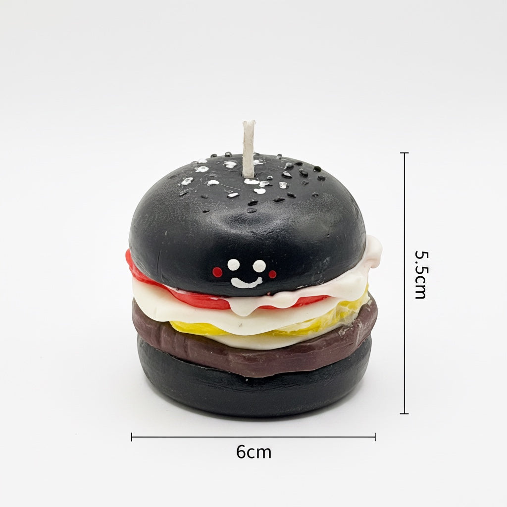 Pepper & White handcrafted burger candle with a black bun, smiling face, and detailed food layers on white background