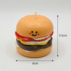 Pepper & White handcrafted burger candle with a cute smiling face, featuring realistic bun, patty, and vegetable layers.