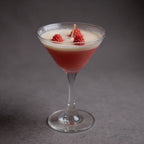 Pepper & White Scarlet Sip cranberry scented candle in a martini glass with wax raspberry decorations