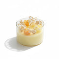 Pepper & White decorative glass jar candle with yellow wax roses and dried baby's breath botanical accents
