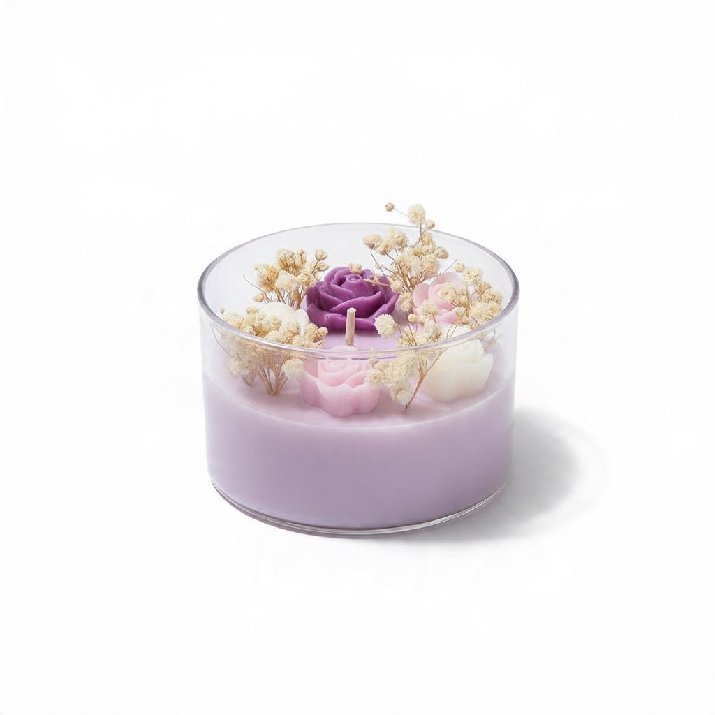 Pepper & White scented candle in a glass jar with purple and pink wax roses and dried baby's breath botanicals.