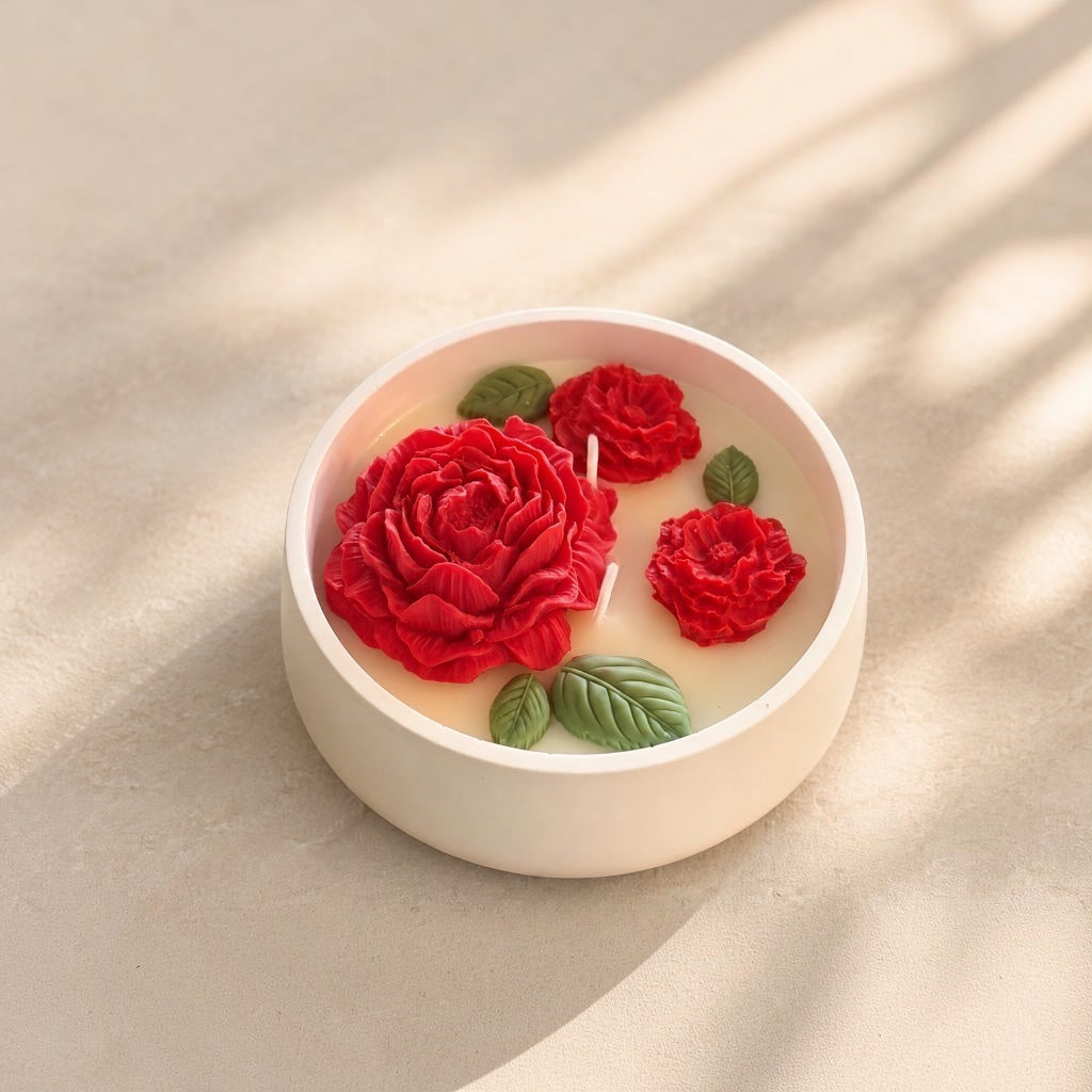 Pepper & White Floral Paradise soy candle in a white ceramic bowl with hand-poured red flower and green leaf wax art.