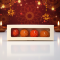 Pepper & White festive Boondi Laddu shaped candles in orange and red, presented in a minimalist gift box.