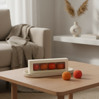 Pepper & White decorative Boondi Laddu-shaped candles in orange and red, displayed on a wooden table in a gift box.