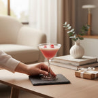 Pepper & White Scarlet Sip strawberry martini candle in a glass with wax raspberry toppings on a slate coaster